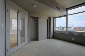 Vacant interior with French Doors and city view