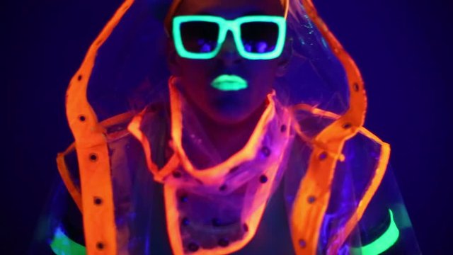 Man is dancing in neon clothes close up