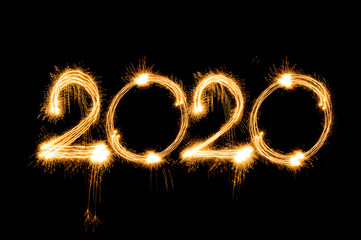 Happy new year 2020 text written with Sparkle fireworks isolated on black background