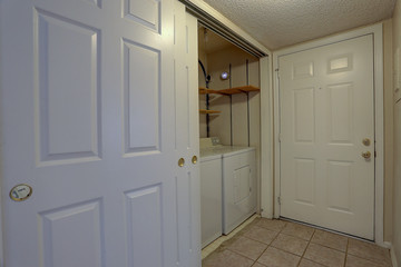 Laundry closet with sliding doors in condominium apartment home