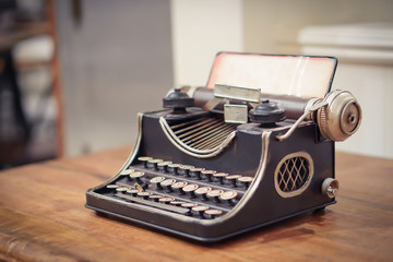 Focus selection:An old typewriter set on a wooden table Retro machine technology
