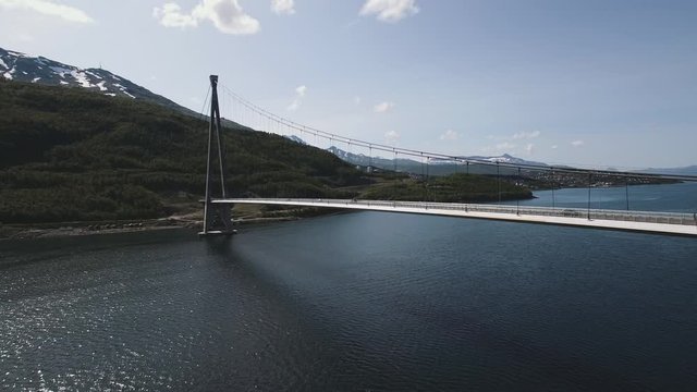 Suspension Bridge In The Arctic. Aerial Drone View. Travel, Nature, Infrastructure Concept. Location: H&aring;logaland Bridge, Rombaken Fjord, Norway. July Of 2019.