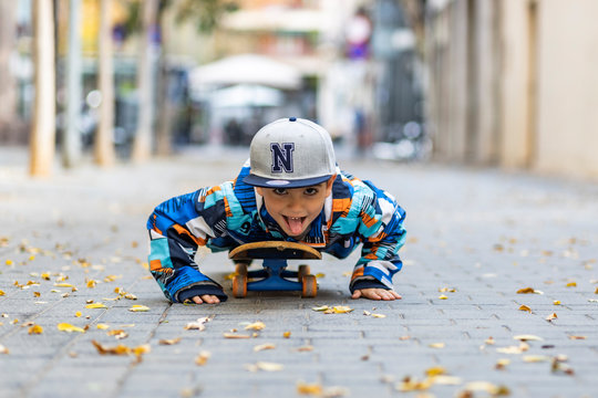 Cute little kid stretched on a skateboard