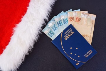 Santa Claus hat, Brazilian passport and Brazilian money. Travel at Christmas concept.
