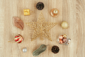 Flat lay Xmas holiday celebration. Greeting card Festive decorations. Christmas objects laid out in the shape of Christmas baubles on wooden background, top view. winter holiday, new year concept.