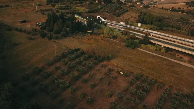 Aerial: Bridge with cars and trucks passing in a beautiful countryside with pastures and meadows in south Germany