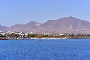 View of the Playa Blanca Harbour, mountains and Lanzarote Island from the ferry, Canary Islands, Spain