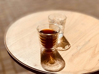 glass of coffee and water On wooden table