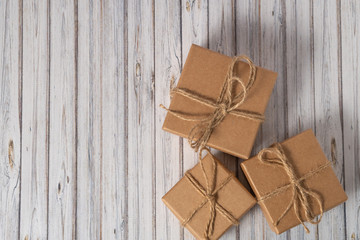 Three cardboard boxes taped on a wooden table. Mail, courier or delivery service concept. Copy space, top view