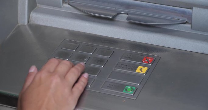 Woman using cash machine for money withdrawal outdoors, closeup