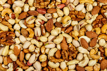 Background of mixed nuts (walnuts, pistachio, almond, peanut, cashew, hazelnut). Healthy eating concept