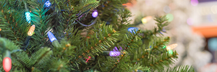 Panoramic close-up artificial Christmas tree and color-changing lights LED at hardware store in USA