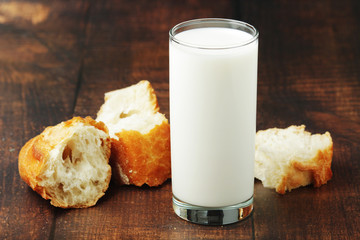 A glass of milk and wheat bread as countryside breakfast	