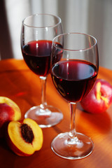 Two glasses with red wine with peaches	