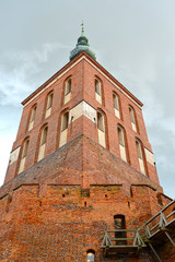 Fototapeta na wymiar Brick cathedral bell tower (17th century), view from below. Frombork, Poland