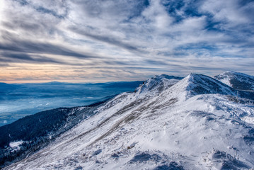 Fototapeta na wymiar beautifully snowy mountains with clouds, slovakia Mala Fatra