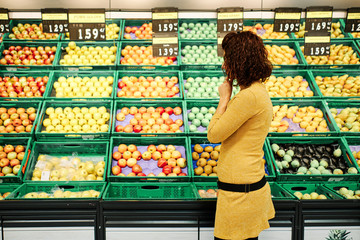 young woman in front of different fruits - diet concept