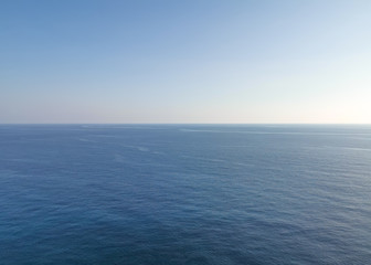 Empty calm blue sea and skyline against a clear sky. Minimalism concept