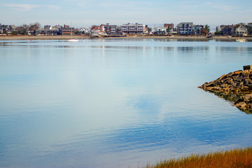 calm water with town in distance; serenity and peaceful