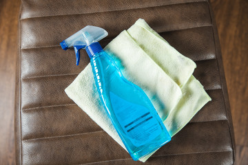 clean liquid on leather chair on gray background