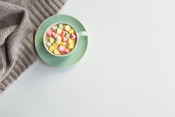 Cup of cocoa with marchmallows on white background