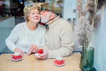 Senior man making marriage proposal to lady,dating sites for elder people.Propose happiness couple elderly caucasian relax weekend lifestyle in coffee shop. View from above.Sun glare Retirement Plan.