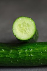 Fresh green cucumbers on a dark background 