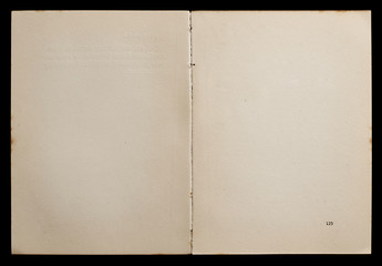 Antique book unfolded showing textured pages isolated on black background.