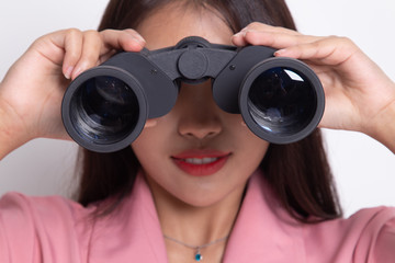 Young Asian woman with binoculars.