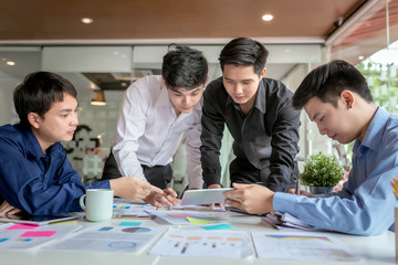 Group of young asian businessman together share opinions and propose new marketing and business ideas at meeting.