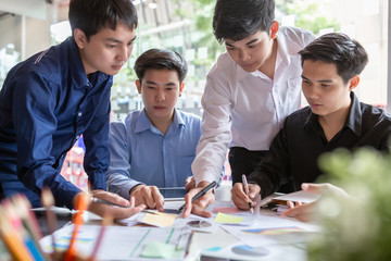 Fototapeta premium Group of young asian businessman together share opinions and propose new marketing and business ideas at meeting.
