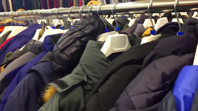shelves with clothes jackets in the mall. Clothing store