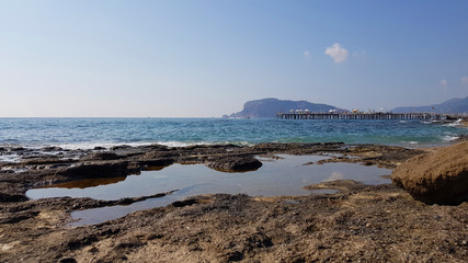 Fototapeta na wymiar Alanya peninsula beyond coast of Mediterranean sea and