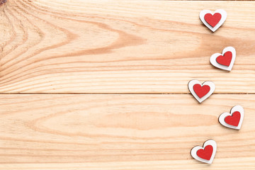 Red and white hearts on brown wooden table