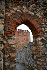 Fototapeta na wymiar View of Red Tower (Kizil Kule) and ancient stone wall of Alanya Castle. Alanya, Turkey