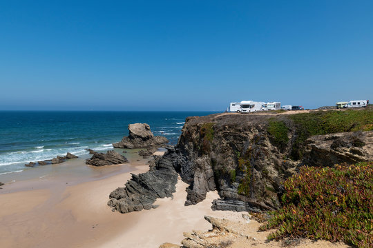 Campers parked on a cliff near the village of Porto Covo, in the Costa Vicentina Natural Park in Portugal; Concept for road trip in Portugal and summer vacations