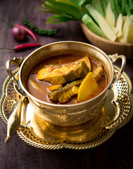 Yellow curry snapper fish with pineapple on wood table,Thai food