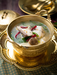 Tom Yum Tilapia fish,Thai spicy soup on wood table,Thai food