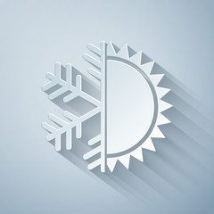 Paper cut Hot and cold symbol. Sun and snowflake icon isolated on grey background. Winter and summer symbol. Paper art style. Vector Illustration