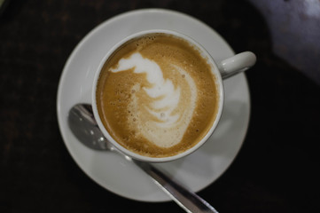 coffee with milk in a white Cup on a black background