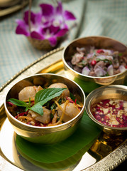 Spicy stir fried fish balls and thai herbs vegetables on wood table,Thai food