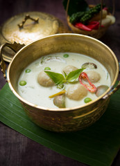 Fish ball green curry, creamy soup, with eggplant on wood table,Thai food