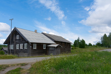 woodpile and cart near a wooden house in the village