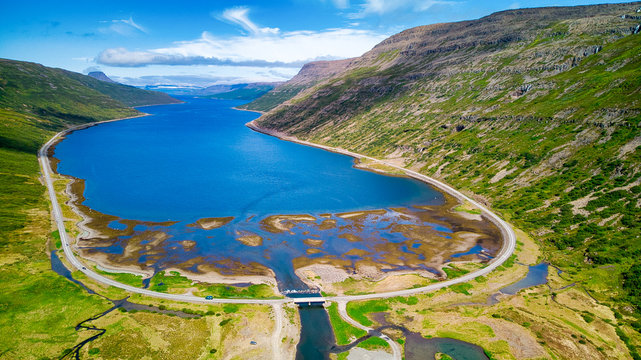 Aerial view over a beautiful Fjord surrounded by large mountains in the Westfjords region of Iceland
