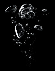 Air bubbles in the water on black background.