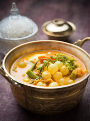 Sour curry soup with spawn and green vegetable on black wooden table,Thai food