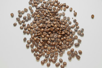 Coffee beans on the white background. with peace of cloth. Brown beans.