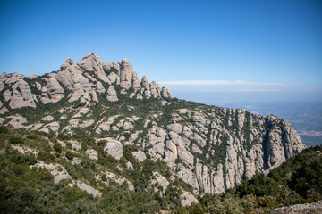 Fototapeta na wymiar Top view of the Montserrat iconic needles with blue sky in Catalonia