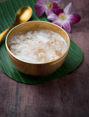 Soybean juice and millet seeds with coconut milk on wood,Thai dessert