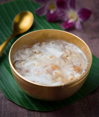 Soybean juice and millet seeds with coconut milk on wood,Thai dessert